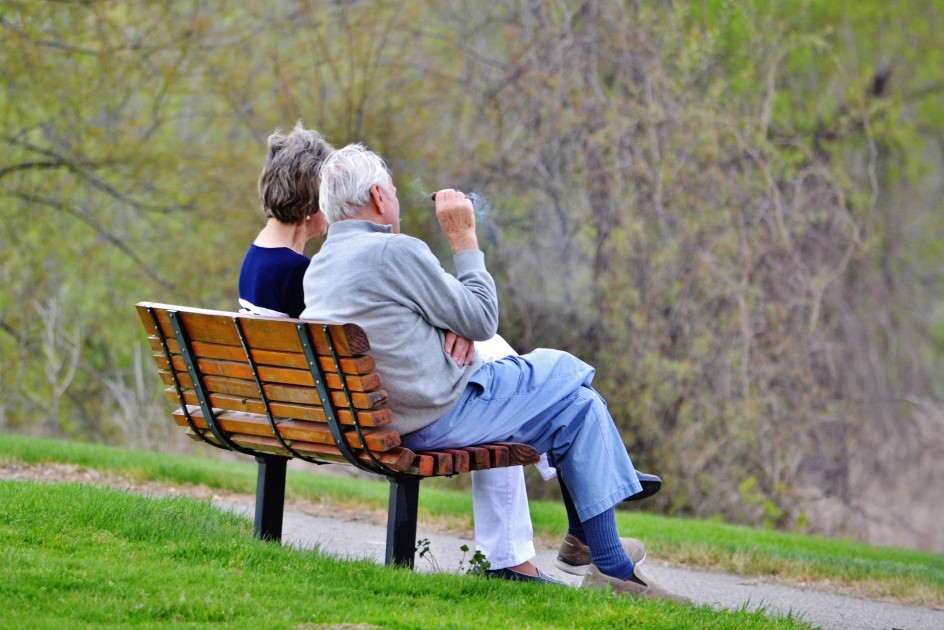 senior citizen sittin on a park talking nonprofit grant