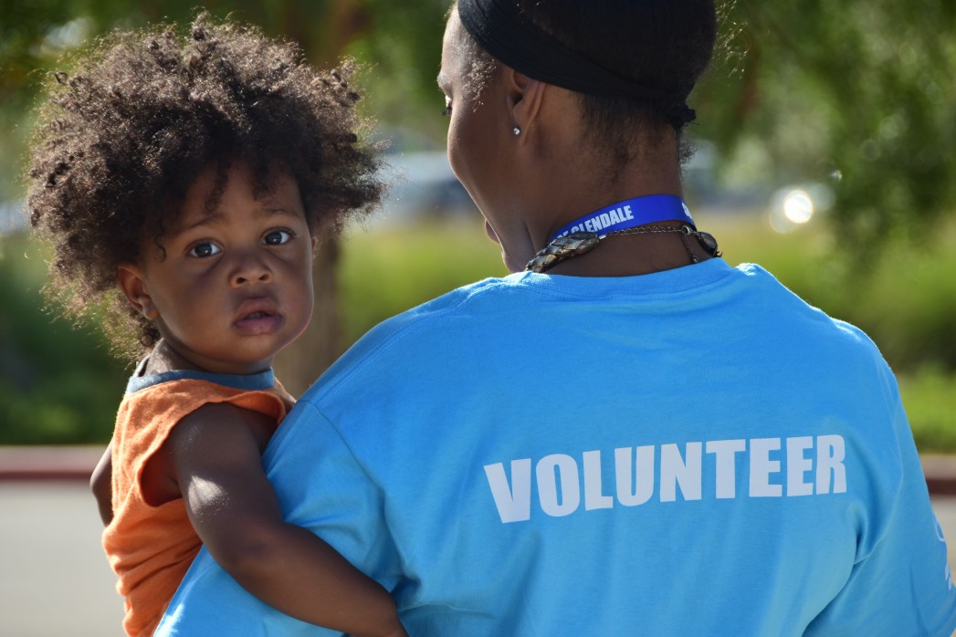 volunteer holding a child