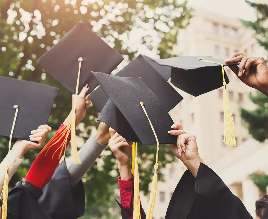 group of graduates throwing caps